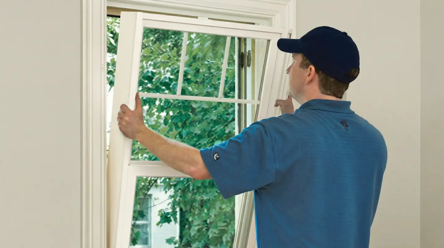 Professional contractors performing a residential window insulation and replacement service in Worcester, MA